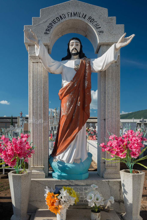 A status of Jesus with outstretched arms in the cemetery in Atotonilquillo, Jalisco.