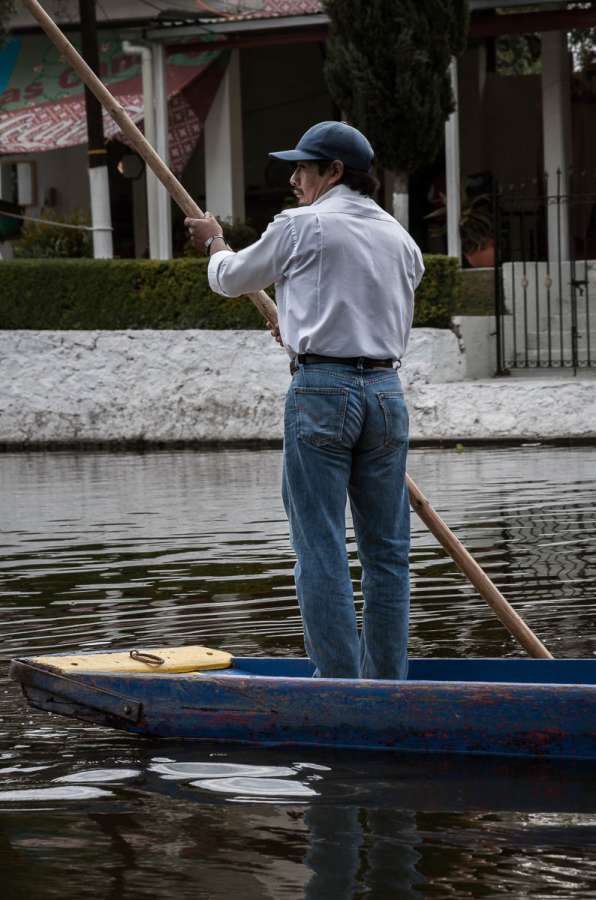 Man operating a trajinera at Xochimilco.