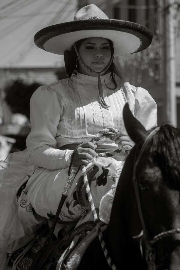 Anna Guitérrez, the quinceañera, riding her horse during the procession after the formal ceremony.