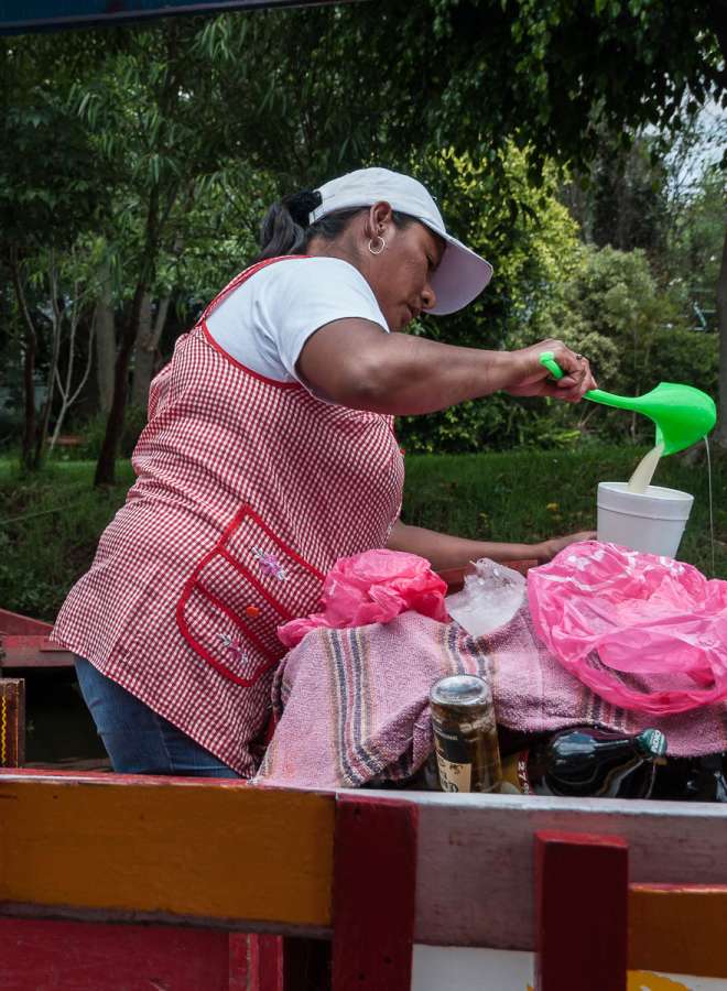 A woman serving pulque at Xochimilco, Mexico.