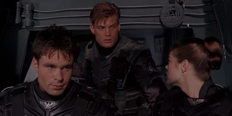 Starship Troopers (1997) movie poster featuring Mobile Infantry soldiers in combat against alien bugs