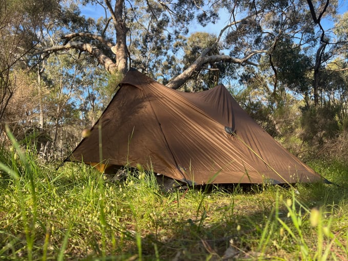 A tent at a grassy campsite