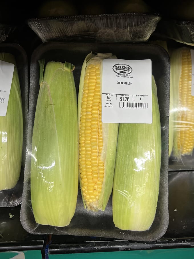 Three corn cobs neatly packaged in styrofoam and shrink wrap