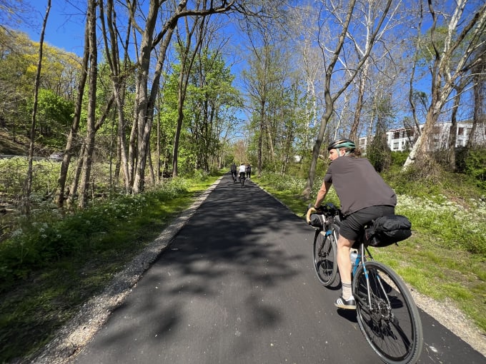 Myles riding on the bike path under a canopy