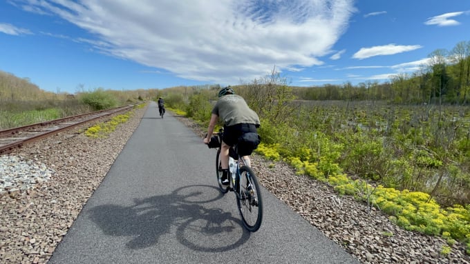 Myles riding on the bike path in marshland