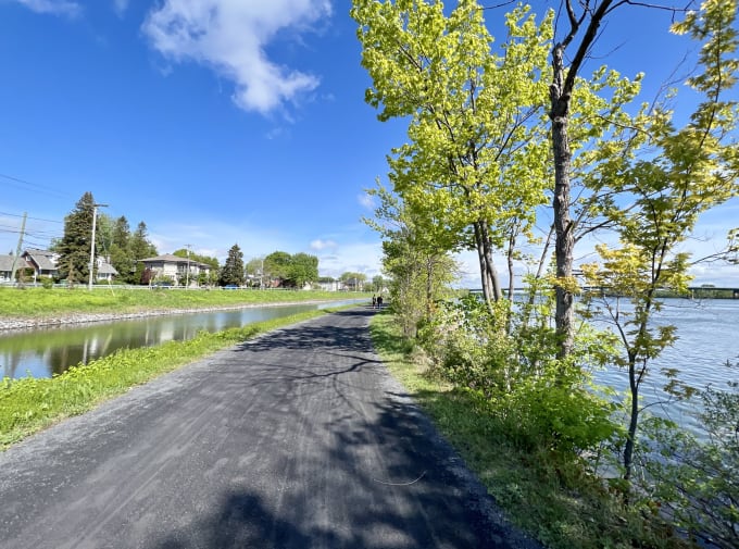 A canal-side bike path on a sunny day