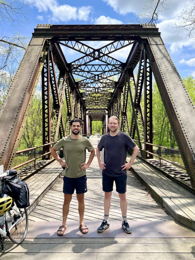 Danny and Myles posing in front of an old bridge