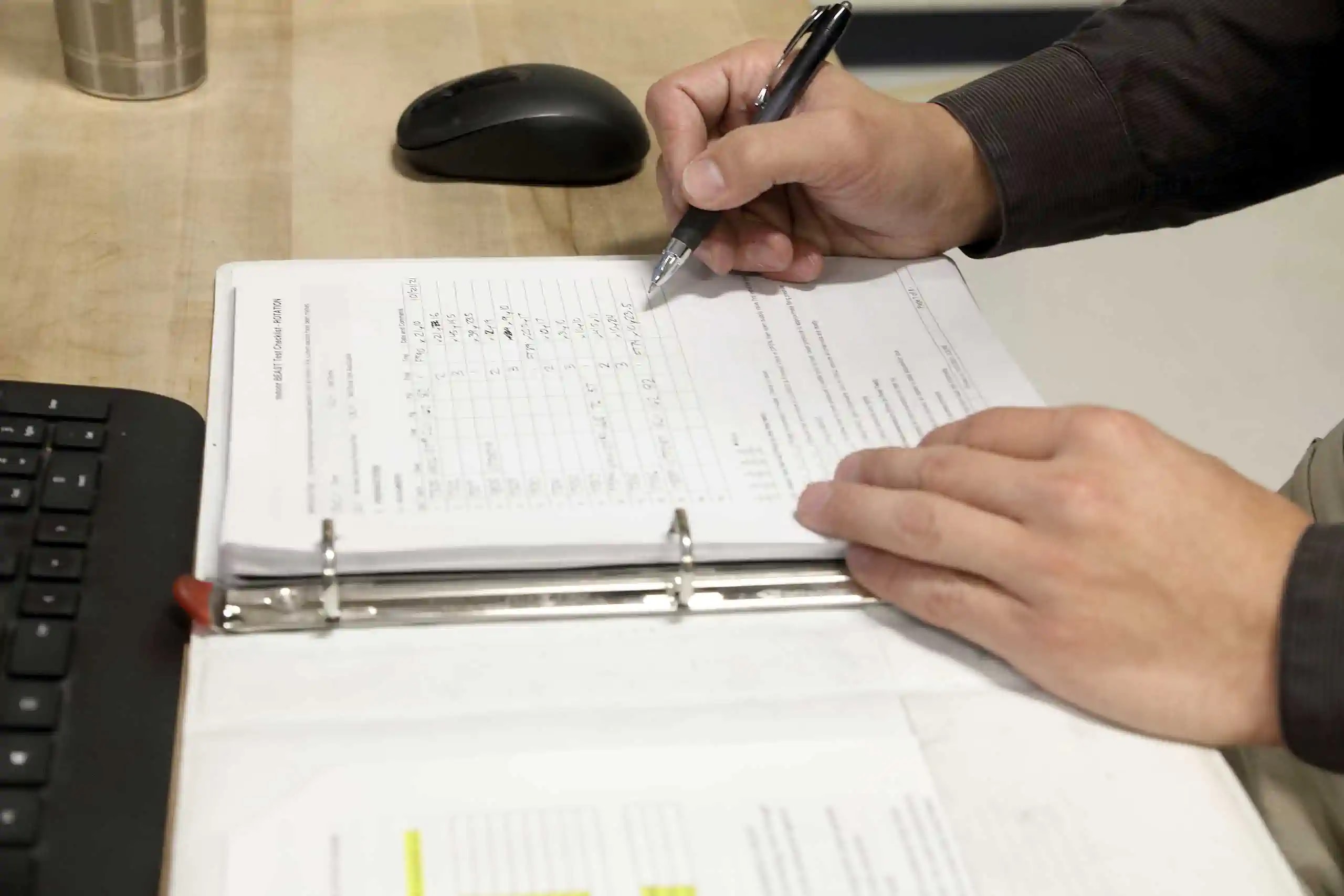 engineer recording data in notebook