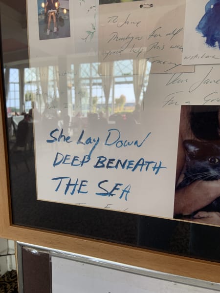 Tracy Emin piece at Walpole Hotel in Maragte, blue handwritten text on white that says She lay down DEEP BENEATH THE SEA