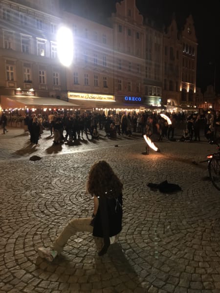 Celes watching a fire artist in main square in Wrocław