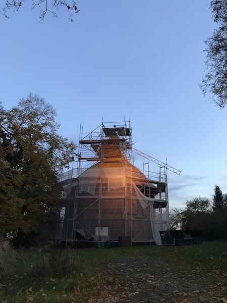 Wooden church in Zwierzyniec under purple-looking sky