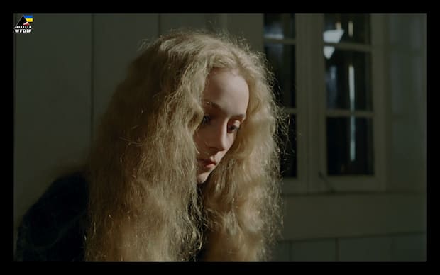 Andrzej Barański - Tabu (1988), blonde in half profile with very curly long hair, poofy, sun shining thru