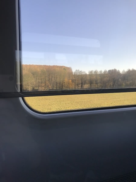 Picture of window on train home, simple feeds blue sky