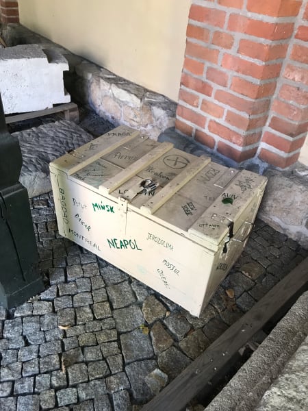 weird old crate with names of cities painted on it in green at jozef czapki pavilion