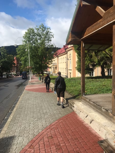 laura and chelsea walking down road in krynica