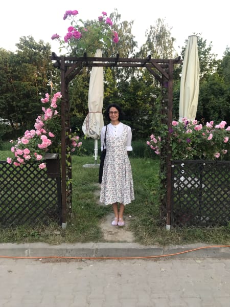 m in flower dress under awning full of flowers