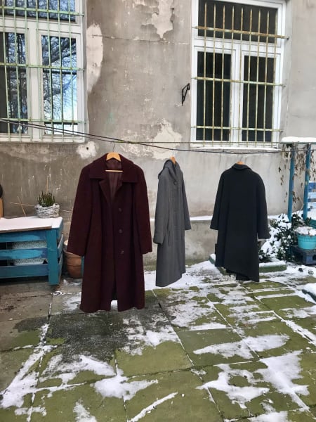 wool coats hanging in the back courtyard