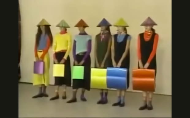 Setsuko Miura - Issey Miyake Moves (2002), five models standing in a line in colourful outfits with conical hats
