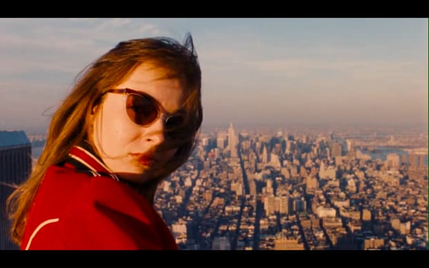 Jon Jost - All the Vermeers in New York (1990), women in sunglasses in new york city skyline in red jacket