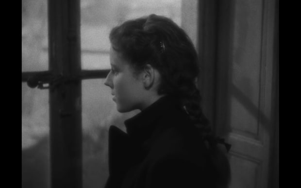 Robert Bresson - Diary of a Country Priest (1951), girl with cool pins in hair standing in profile at a window