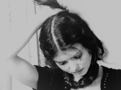 portrait of anne gillis wrapping her hair around her neck