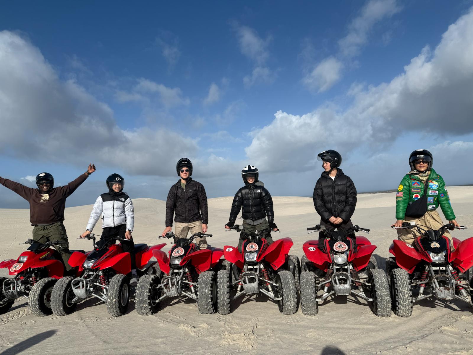 Rider on quad bike across the dunes
