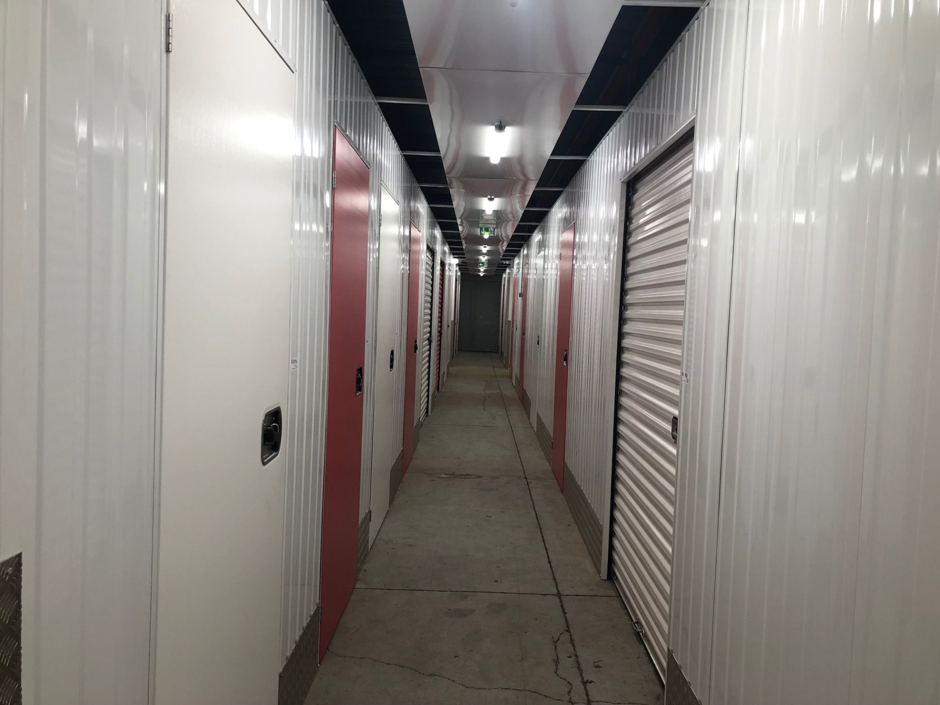 Couloir intérieur avec box rouges et blancs au centre HOMEBOX Dreux.
