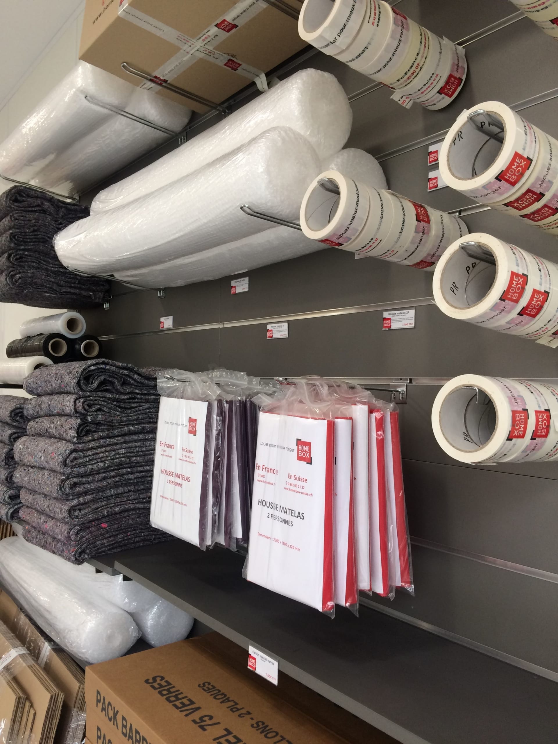 Présentoir d'accessoires de déménagement avec cartons, housses matelas, adhésifs et couvertures du centre HOMEBOX Lorient