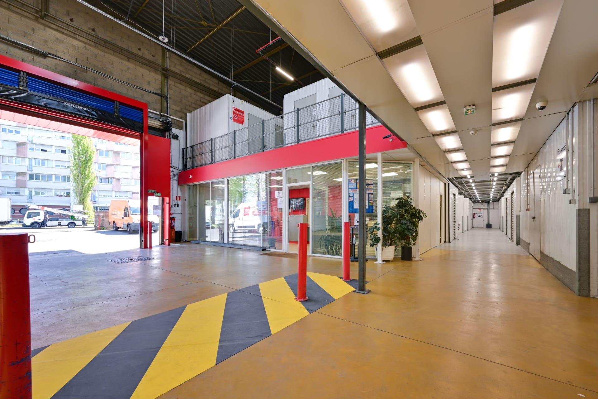 Vue depuis l’intérieur de la zone de déchargement du centre HOMEBOX Bagnolet vers l’extérieur et le couloir d’accès aux box.
