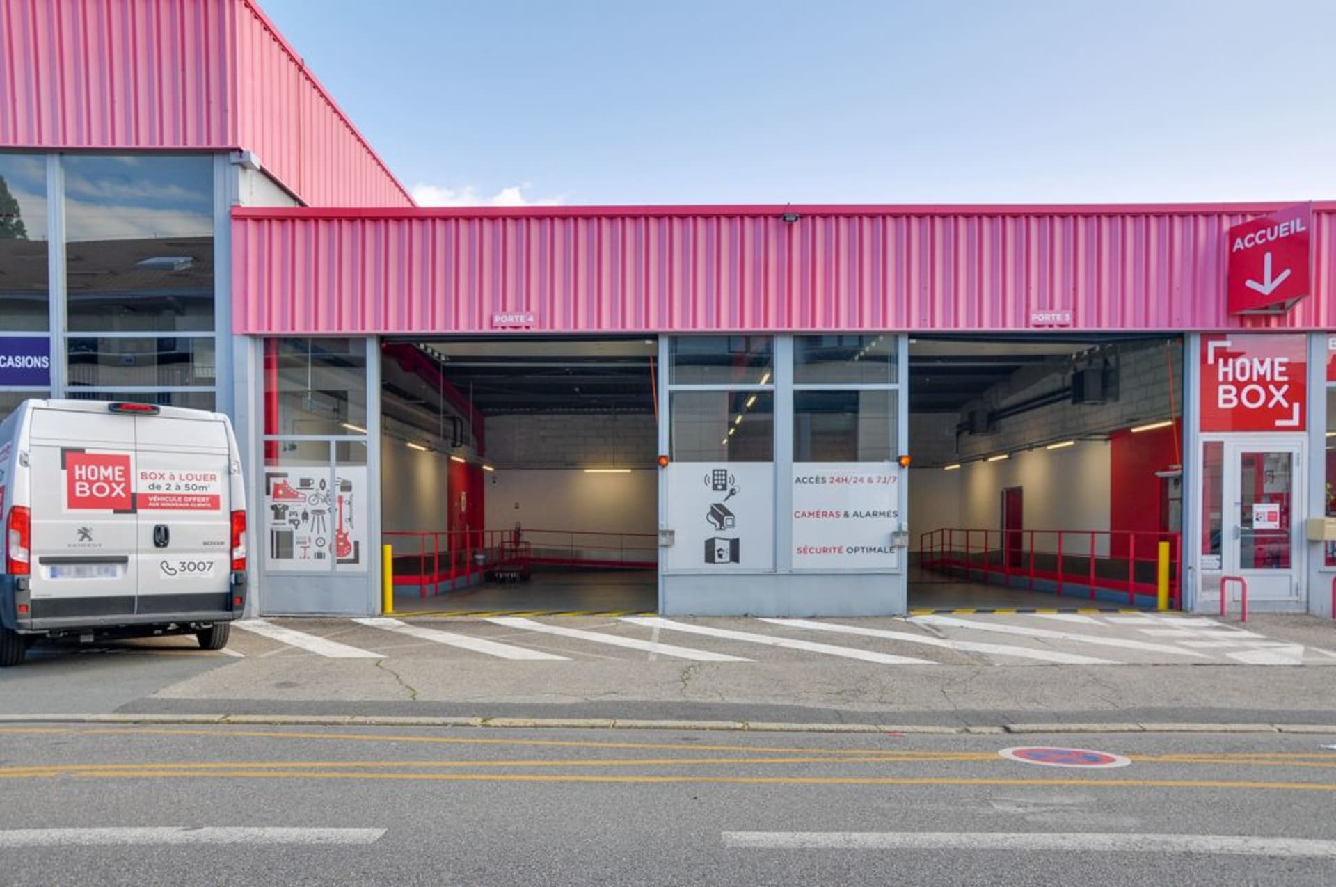 Open loading bays and branded van in front of pink storage facility at HOMEBOX Saint-Etienne, 24 rue du Mont, Saint-Etienne
