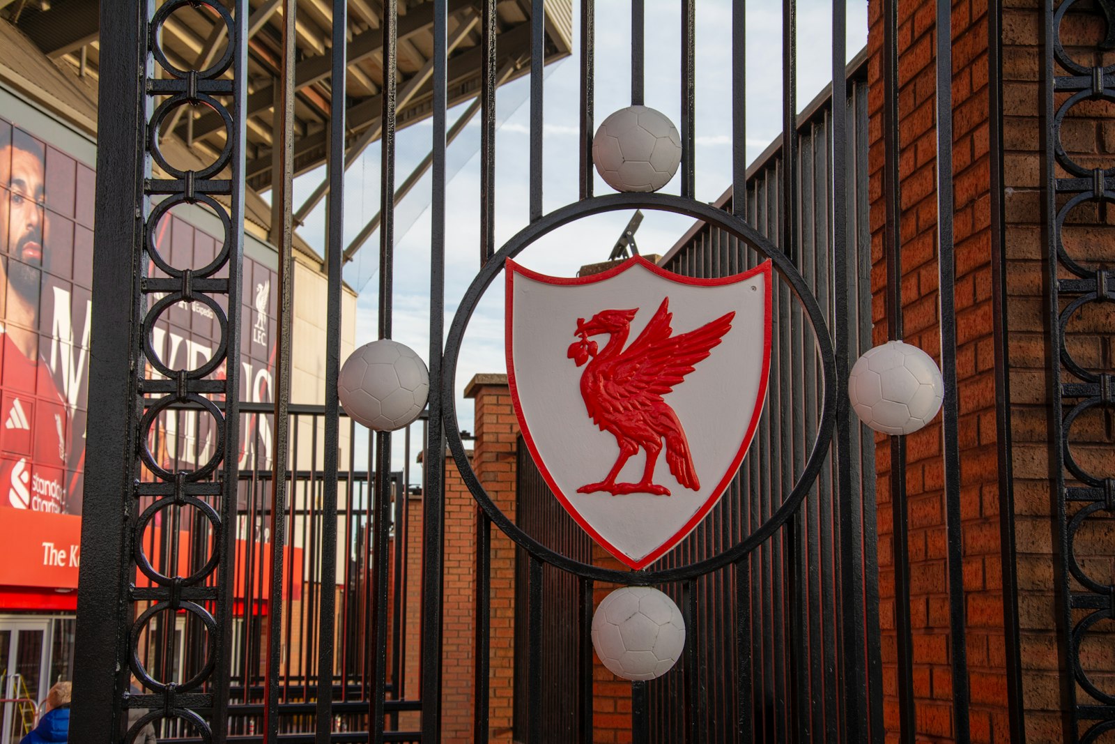 Liverpool FC emblem on metal gate outside Anfield