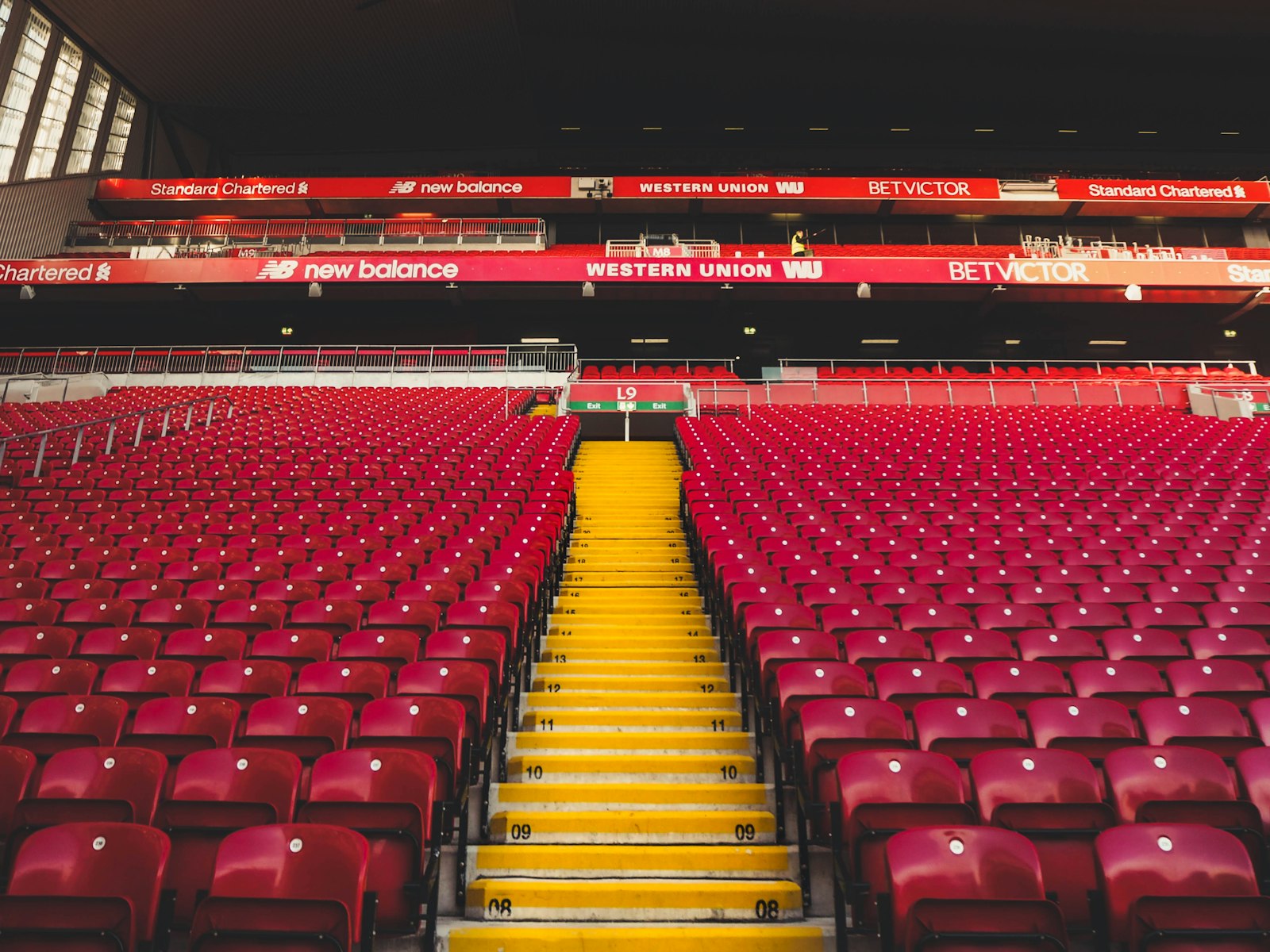 Red seats at Anfield Stadium in daylight