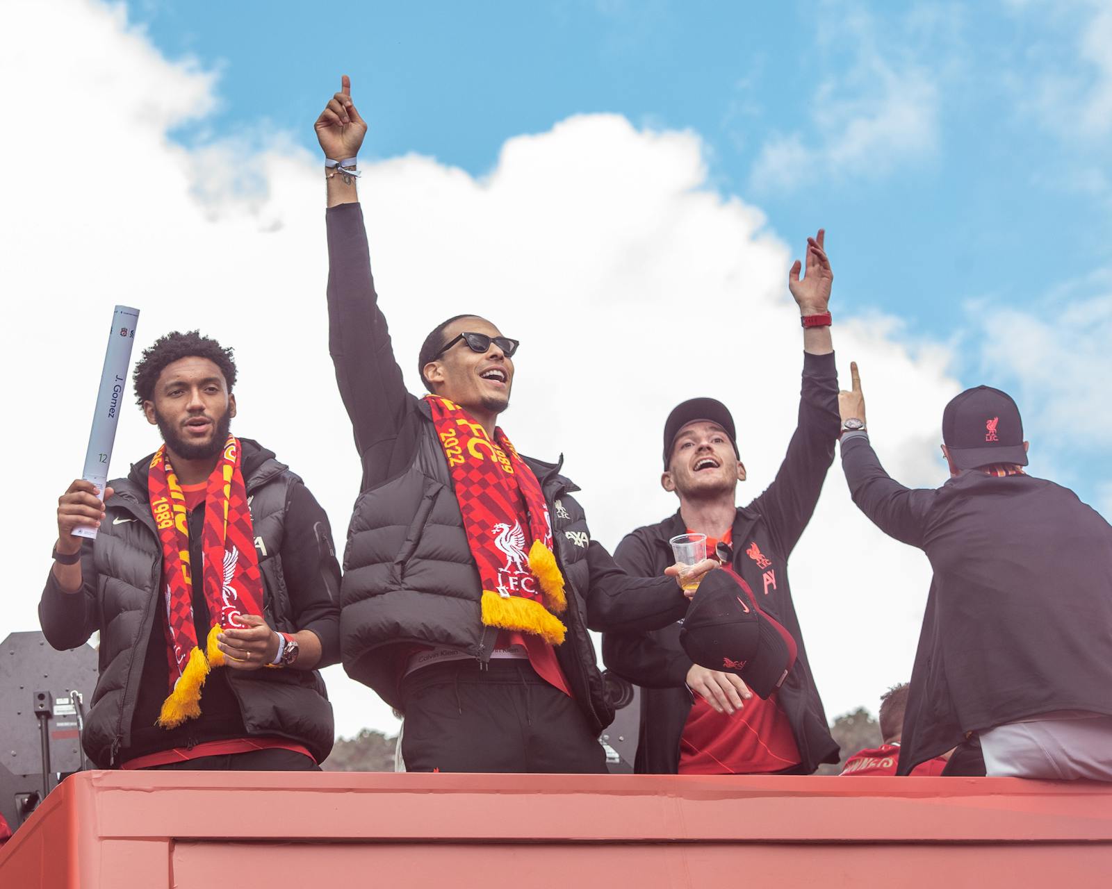 Fans celebrating with Liverpool FC players during victory parade