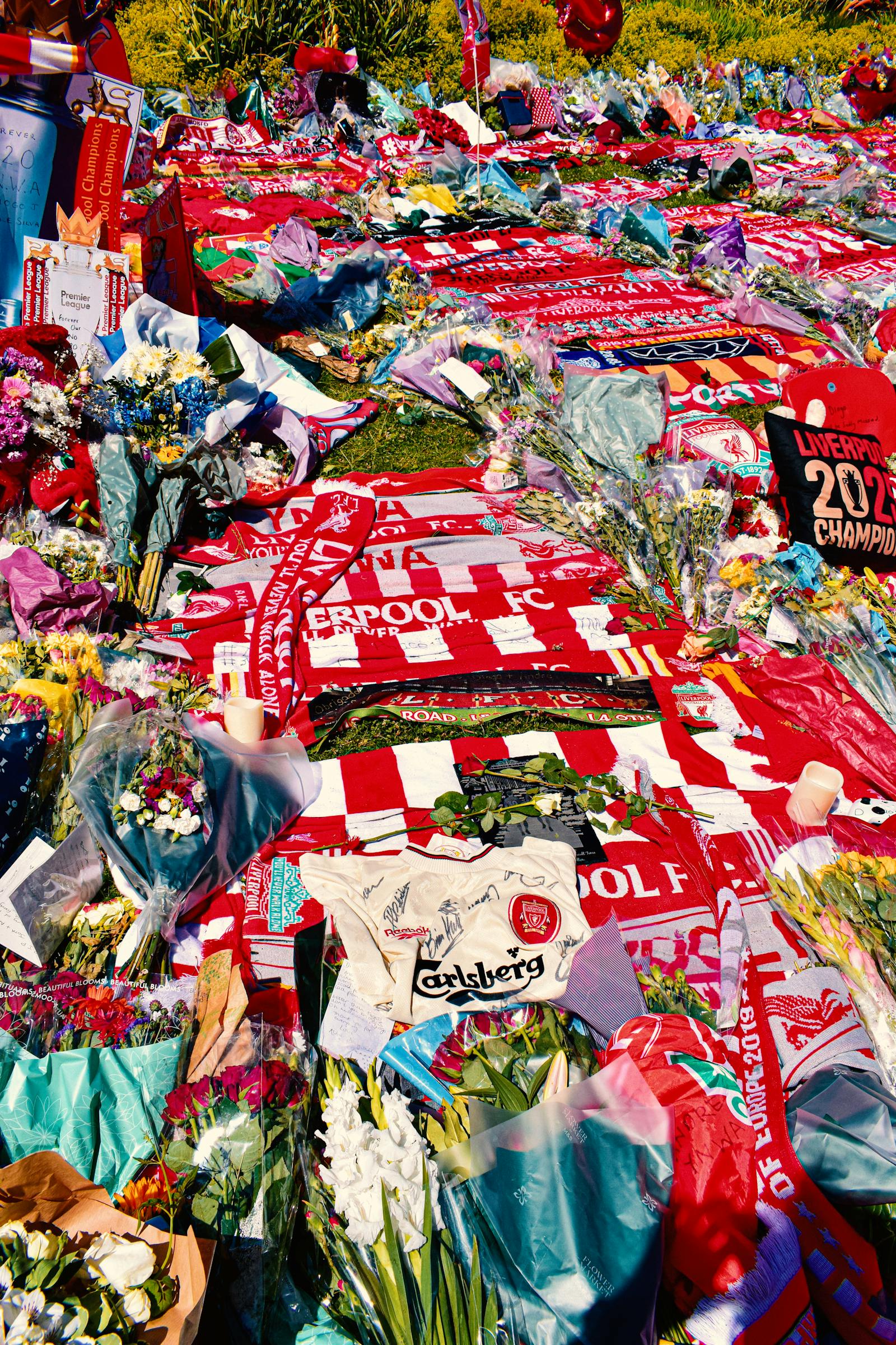 Hillsborough memorial tribute with floral arrangements and Liverpool memorabilia