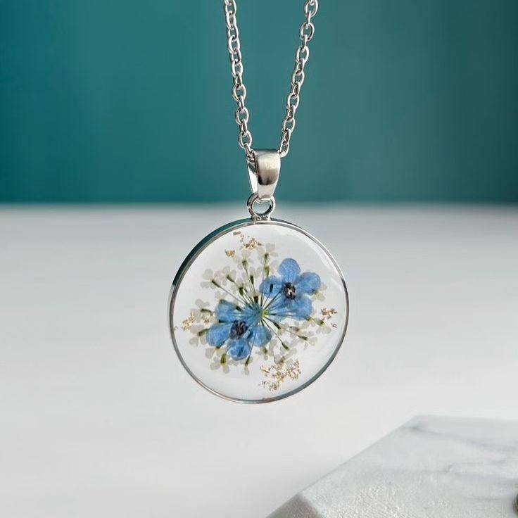 Serene Blue Floral Resin Necklace | Round Silver Bezel