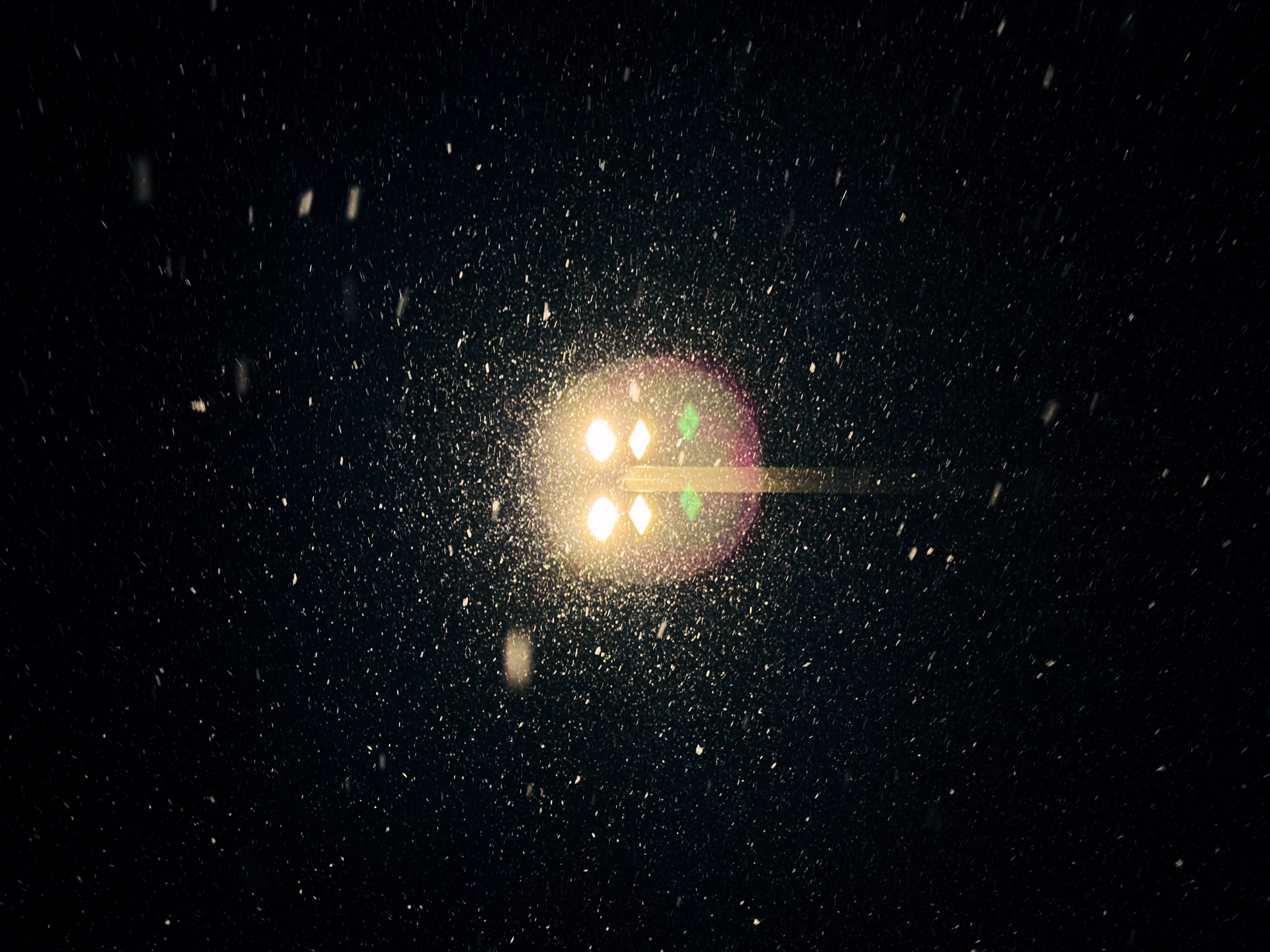 The heavy snow fall lit by a streetlight