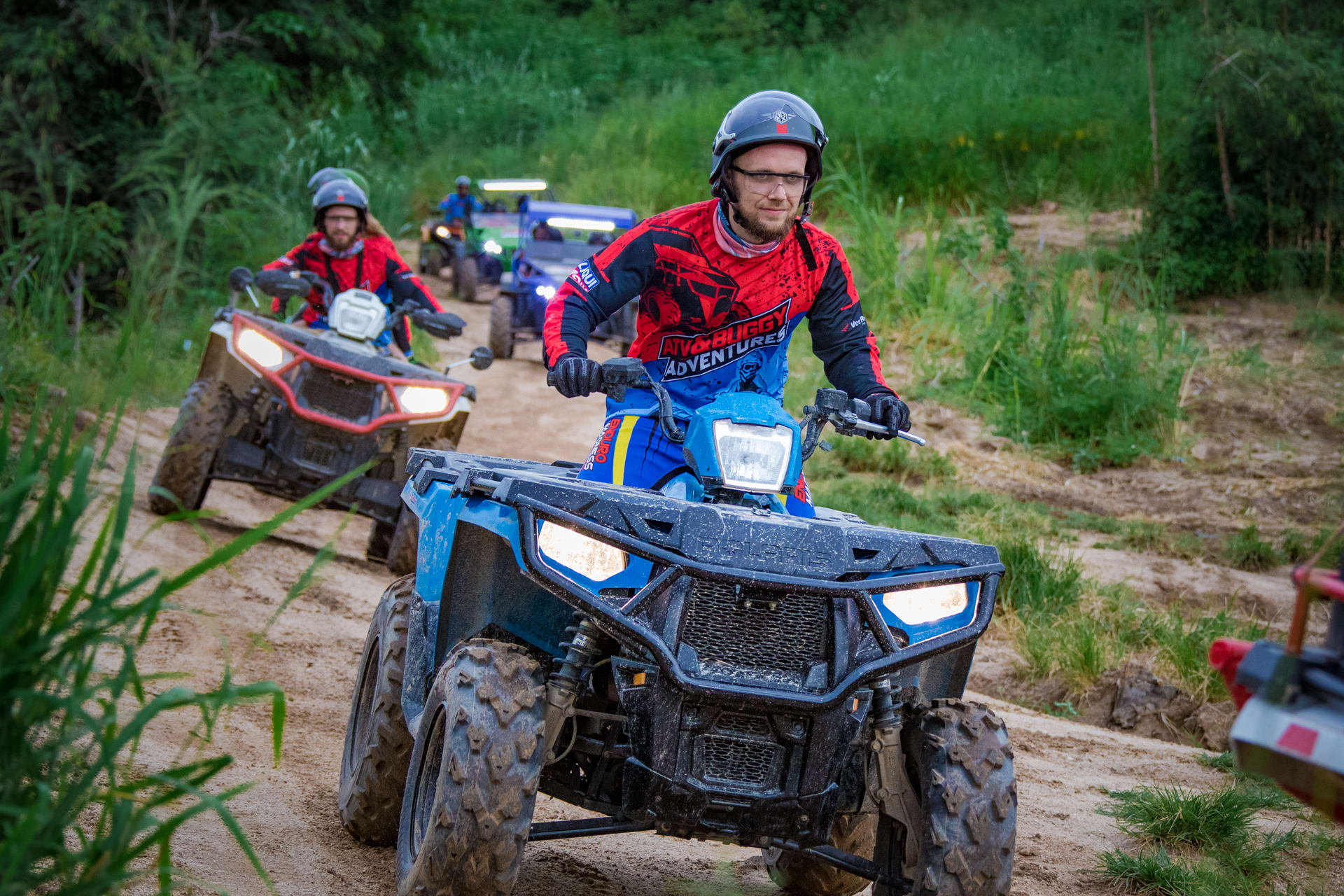 ATV riders following their guide through a jungle trail near Pattaya