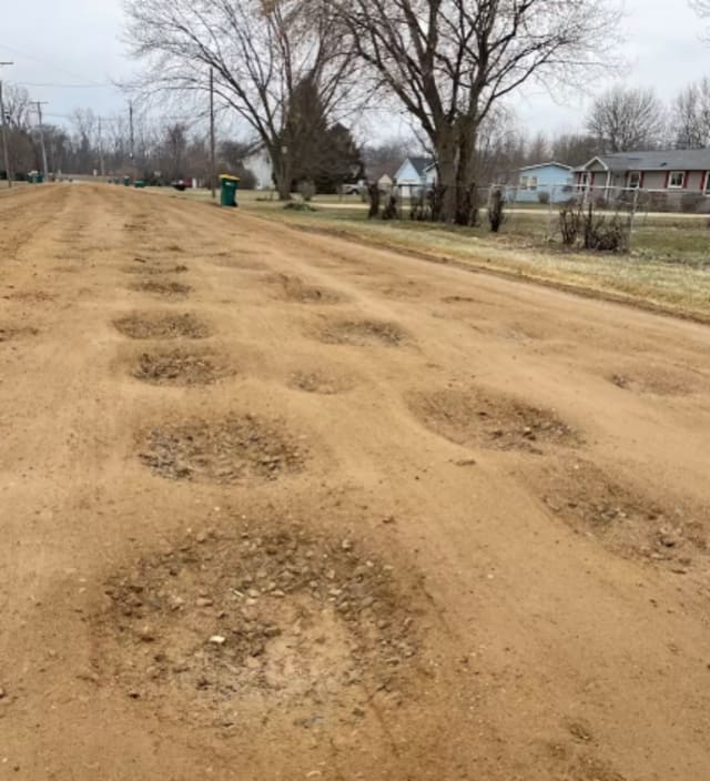 Damaged rough driveway before repair
