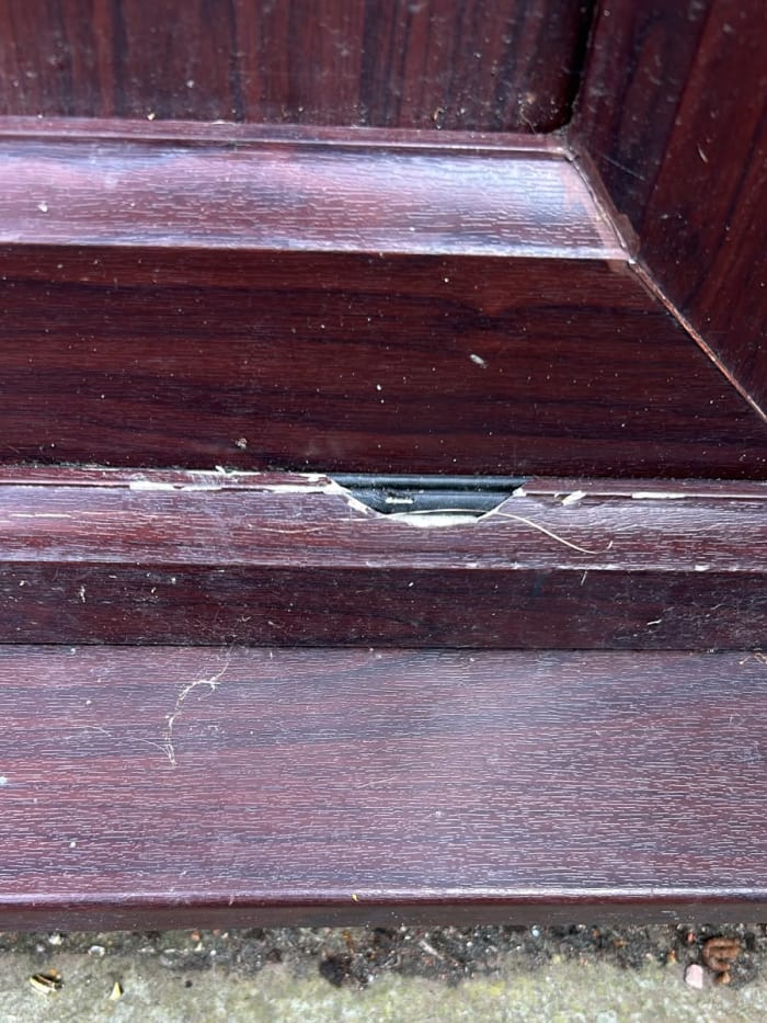 The UPVC door with a chip and a missing section
