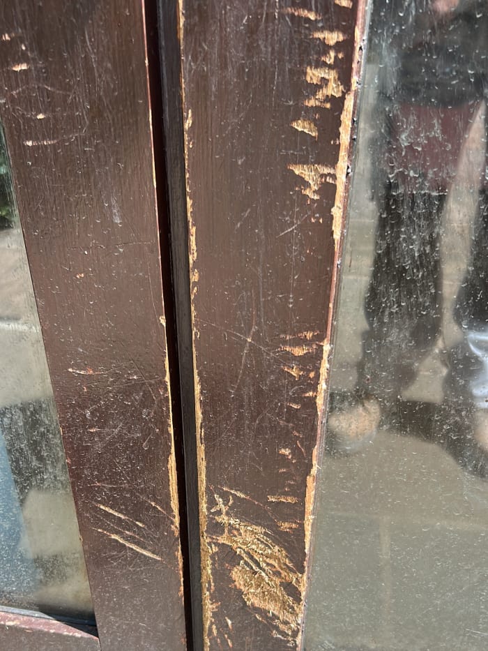 The French door damage up close, torn and scratched