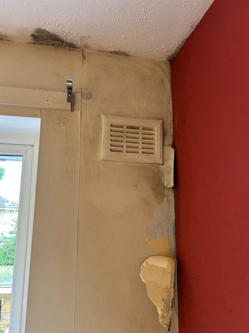 Window corner before resurfacing, with staining and damaged plaster in Lymm