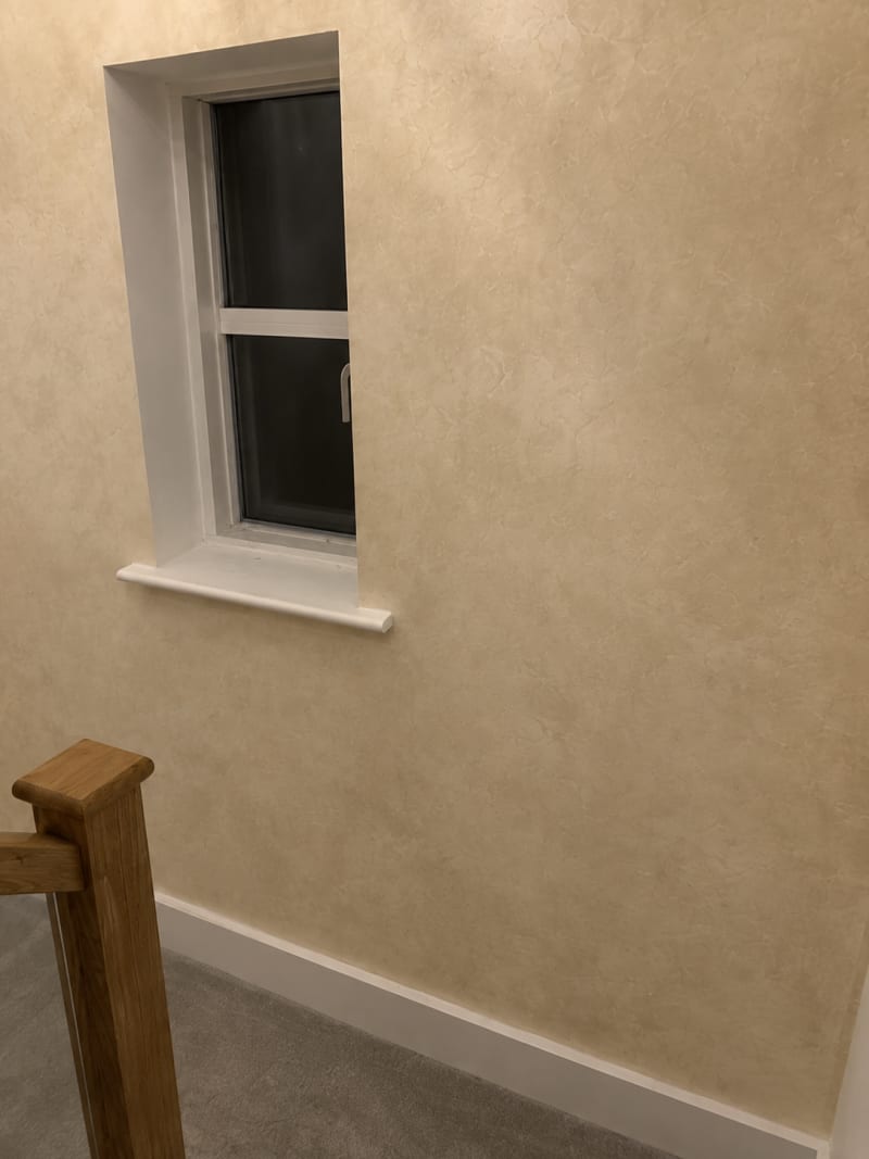 Close view of a limewashed wall showing tonal movement across the surface