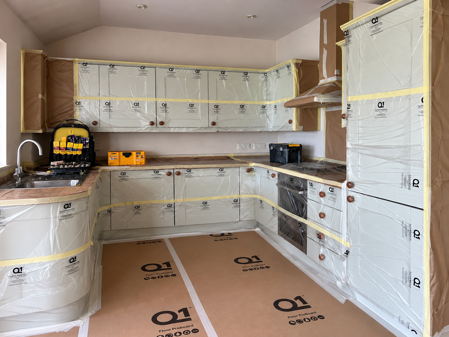 Kitchen wrapped and protected before spray work