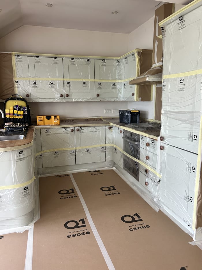 Kitchen units masked and wrapped with Q1 protection before decorating