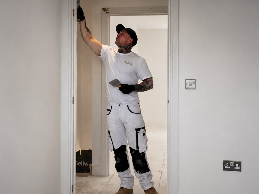 Decorator filling frames — thorough preparation before painting