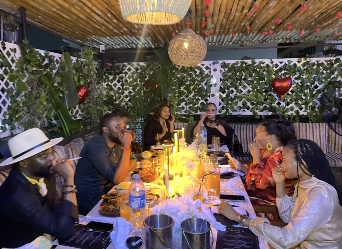 A guest laughing and toasting at The Mood Table