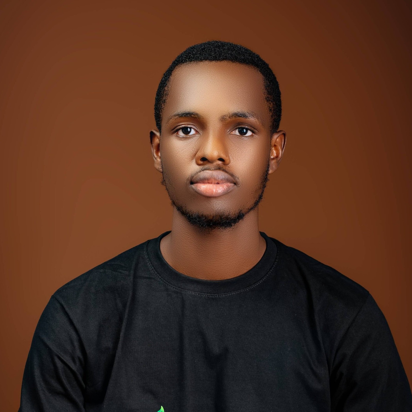 Professional headshot of African female technology executive wearing teal blazer with warm smile in corporate environment