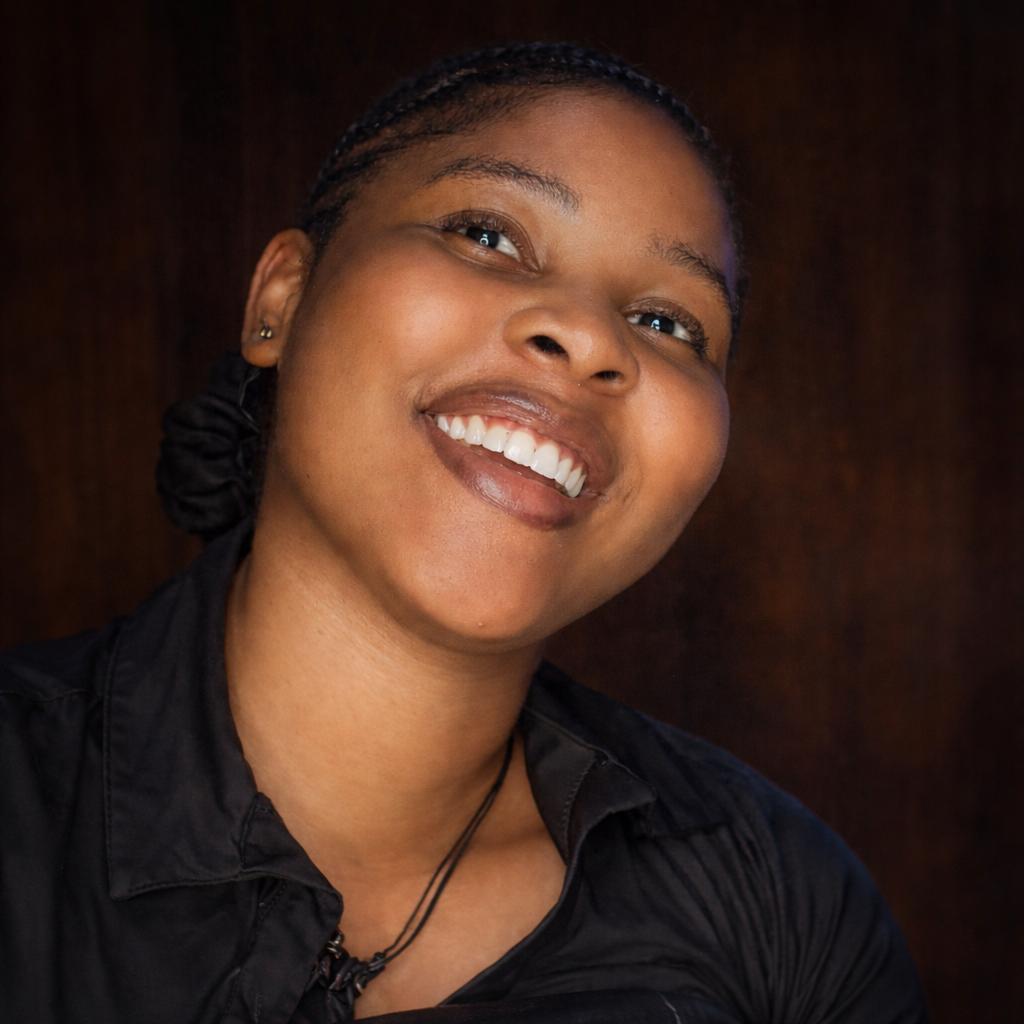 Professional portrait of African female compliance officer in formal business suit with serious expression