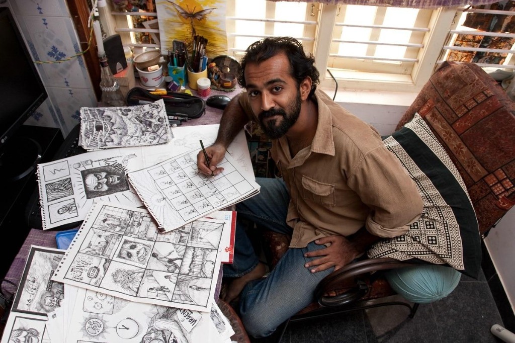 Independent comic creator working at a drafting table