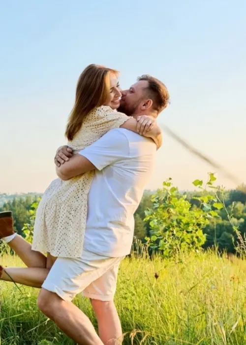 Couple embracing outdoors in a field